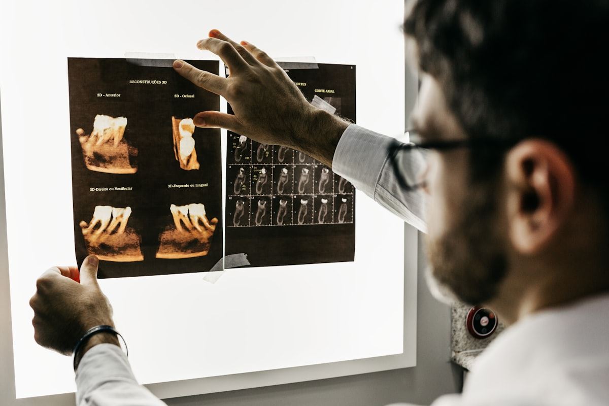 A dentist examining X-ray films of teeth and jaw bone